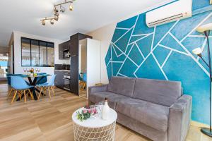a living room with a couch and a table at Vue mer port de garavan in Menton