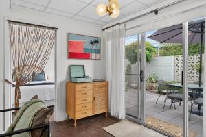 a bedroom with a bed and a desk with a computer at Sixty at Yellow Doors in Goolwa South