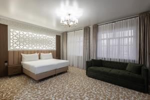 a bedroom with a bed and a couch at Boutique Hotel Tomiris in Astana +90 photos