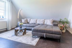 a living room with a couch and a table at Ferienwohnung Tina OG in Boltenhagen