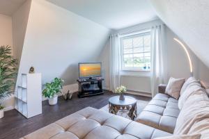 a living room with a couch and a tv at Ferienwohnung Tina OG in Boltenhagen