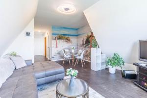a living room with a couch and a table at Ferienwohnung Tina OG in Boltenhagen