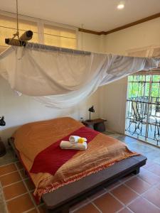 a bedroom with a bed with two towels on it at Baan Rim Tarn B&B in Takua Pa