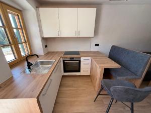 a small kitchen with a sink and a counter at Ferienwohnung Almzeit in Gressenberg