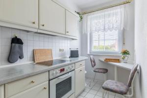 a kitchen with a sink and a stove top oven at Ferienwohnung Tina EG in Boltenhagen