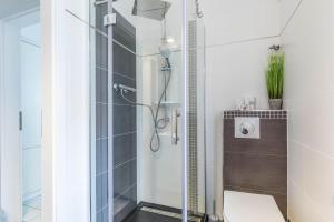 a bathroom with a glass shower with a toilet at Ferienwohnung Tina EG in Boltenhagen +9 photos