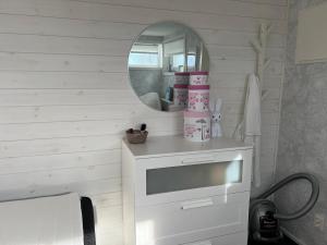 a bathroom with a white vanity and a mirror at house with sea view in Varberg