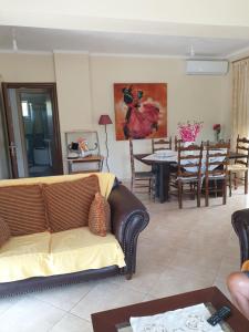 a living room with a couch and a table at Εξοχικό Σταμάτη in Lóngos +12 photos