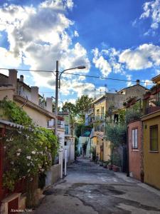 an empty alley with buildings and a street light at Lo Squero Guest House in Fano