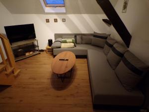 a living room with a couch and a wooden table at Ferienwohnung Hummel in Aurich