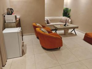 a living room with two chairs and a table at NOVA Homes in Medina