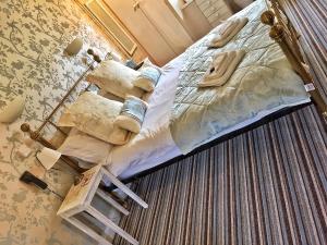 a large bed in a bedroom with a ladder on it at The Hand at Llanarmon in Llanarmon Dyffryn-Ceiriog