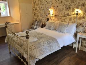 a bedroom with a bed and a chair at The Hand at Llanarmon in Llanarmon Dyffryn-Ceiriog