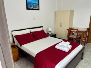 a bedroom with a bed with two towels on it at Villa Festim Ksamil in Ksamil