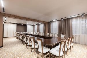 a conference room with a long table and chairs at Boutique Hotel Tomiris in Astana