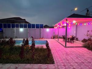 a patio with a table and purple lights at Relax Gabala in Gabala