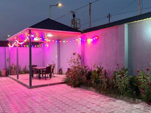 a patio with a table and purple lights at Relax Gabala in Gabala