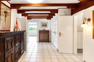 a kitchen with white walls and wooden ceilings at Lund36 in Husum