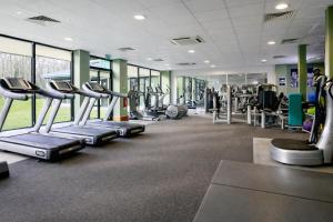 a gym with rows of treadmills and machines at Macdonald Hill Valley Hotel, Spa & Golf Resort in Whitchurch