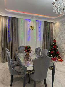 a dining room with a table and a christmas tree at Relax Gabala in Gabala