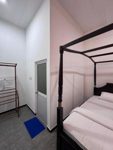 a bedroom with a canopy bed and a window at Una Stay in Unawatuna