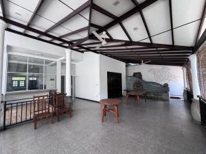 a living room with chairs and a table and a couch at Una Stay in Unawatuna