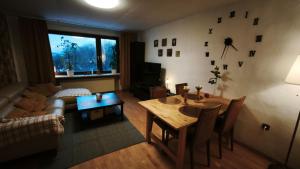 a living room with a table and a couch at Märchen Apartment in Niestetal