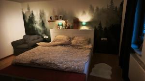 a small bedroom with a bed and a chair at Märchen Apartment in Niestetal
