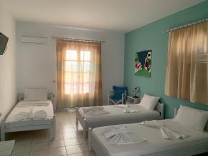 a room with two beds and a window at Melissa Rooms in Koufonisia