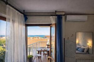 a room with a balcony with a table and a view at Sea View Solarium- Free parking - 8 min beach - 3 min A14 - Mastrangelo Beach in Grottammare