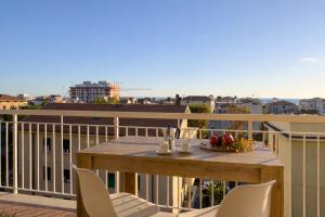 a table and chairs on a balcony with a view at Sea View Solarium- Free parking - 8 min beach - 3 min A14 - Mastrangelo Beach in Grottammare +14 photos