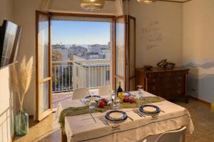 a dining room with a table and a large window at Sea View Solarium- Free parking - 8 min beach - 3 min A14 - Mastrangelo Beach in Grottammare