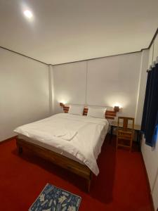 a bedroom with a large white bed in a room at Thavisok Guest House in Nongkhiaw