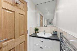 a bathroom with a sink and a mirror at Stylish Roman Bath Abode - The Gatsby in Bath