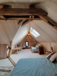 an attic room with a bed and a window at L'atypique du buisson de la gariole in Aubigny-sur-Nère +67 photos