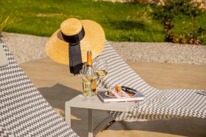 a straw hat sitting on a table with a bottle of wine at Fior di Noto in Noto
