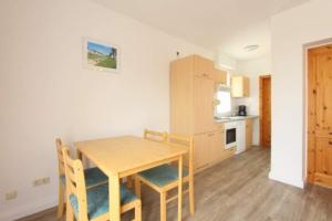 a kitchen and dining room with a table and chairs at Bungalow Marina Tarnewitz in Tarnewitz
