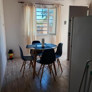 a table and chairs in a room with a window at Terramar cabañas in Mar del Plata