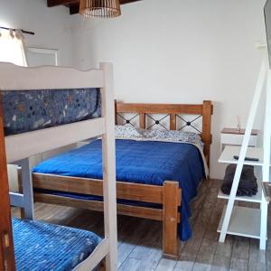 a bedroom with two bunk beds and a ladder at Terramar cabañas in Mar del Plata