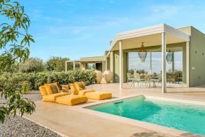a backyard with a swimming pool and a house at Fior di Noto in Noto +39 photos