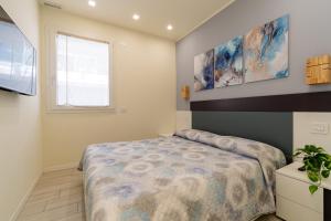 a bedroom with a large bed and a window at Residenza Agave in Boario Terme