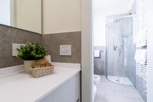 a bathroom with a sink and a toilet and a shower at Residenza Agave in Boario Terme