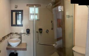 a bathroom with a shower with a toilet and a sink at Suites Aldama in Toluca +27 photos
