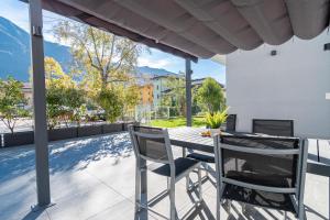 a table and chairs on a patio with a view at Residenza Agave in Boario Terme