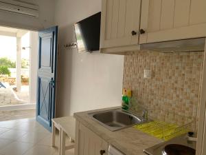 a kitchen with a sink and a counter top at Melissa Chora in Koufonisia +19 photos