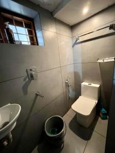 a bathroom with a white toilet and a sink at Dragster Homes Alwaye in Alwaye +49 photos