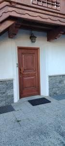 a brown door on the side of a house at La Dimora della Quiete in Valdidentro