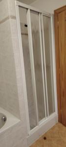 a shower with glass doors in a bathroom at La Dimora della Quiete in Valdidentro