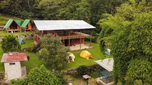 an aerial view of a house with a roof at ALPHINA CABINS Qhapaq Ñan in Sahuayacu +13 photos