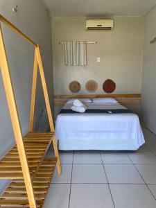 a bedroom with a bed and a staircase at Pousada Barlavento in Luis Correia